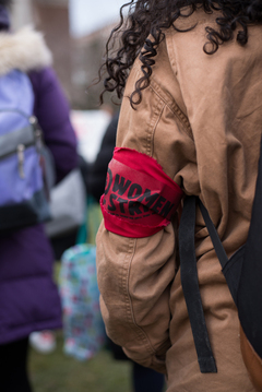 A demonstrator wears a red 